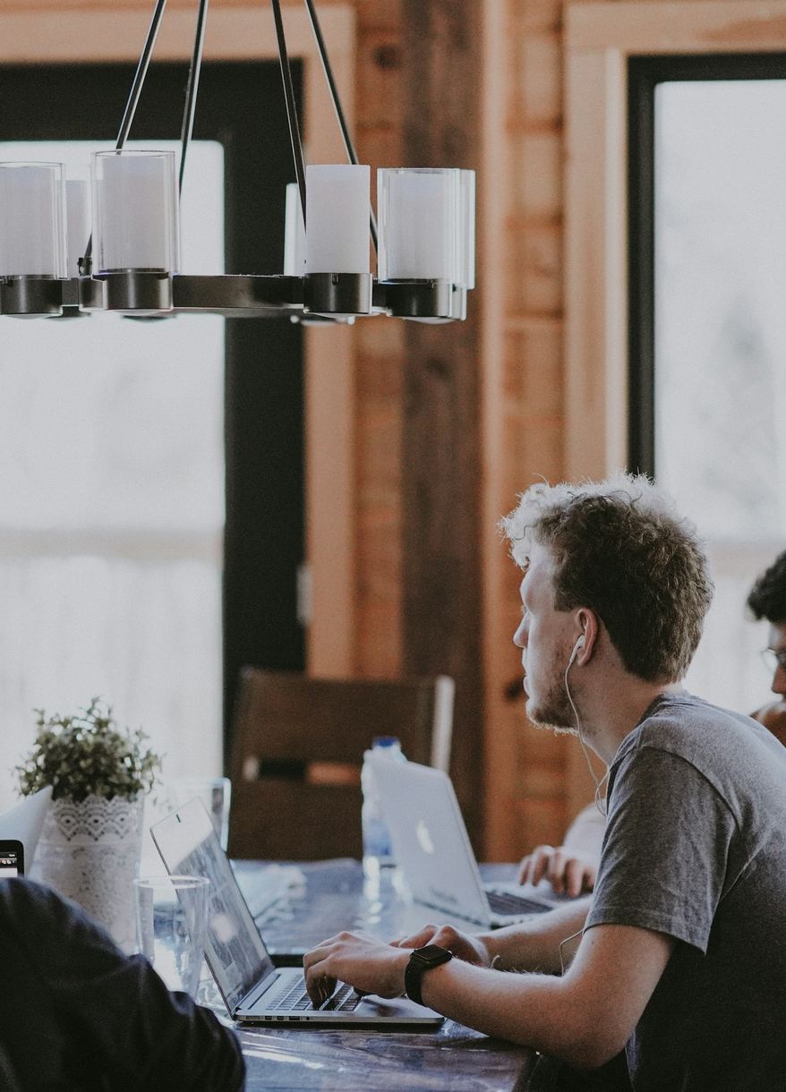 A team working together on laptops around a shared table